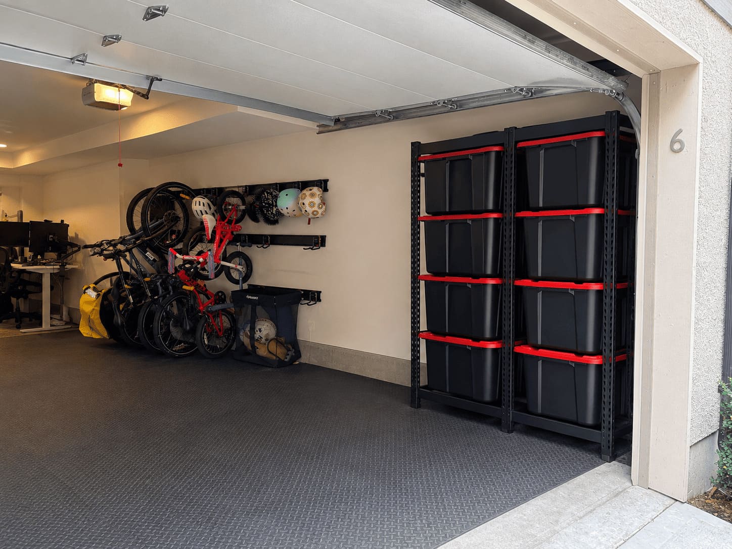 Starter package installed in a Coquitlam garage — wall rails, bike mounts and an eight-bin steel rack