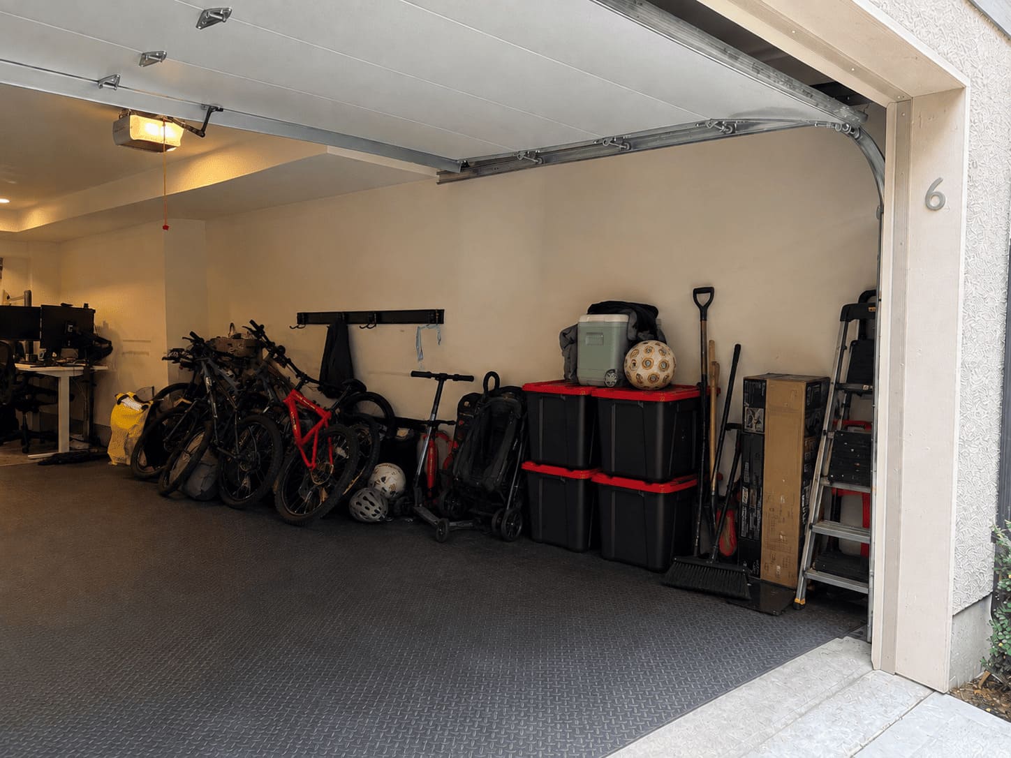 Coquitlam garage before Bolt Garage: bikes, bins and gear stacked on the floor
